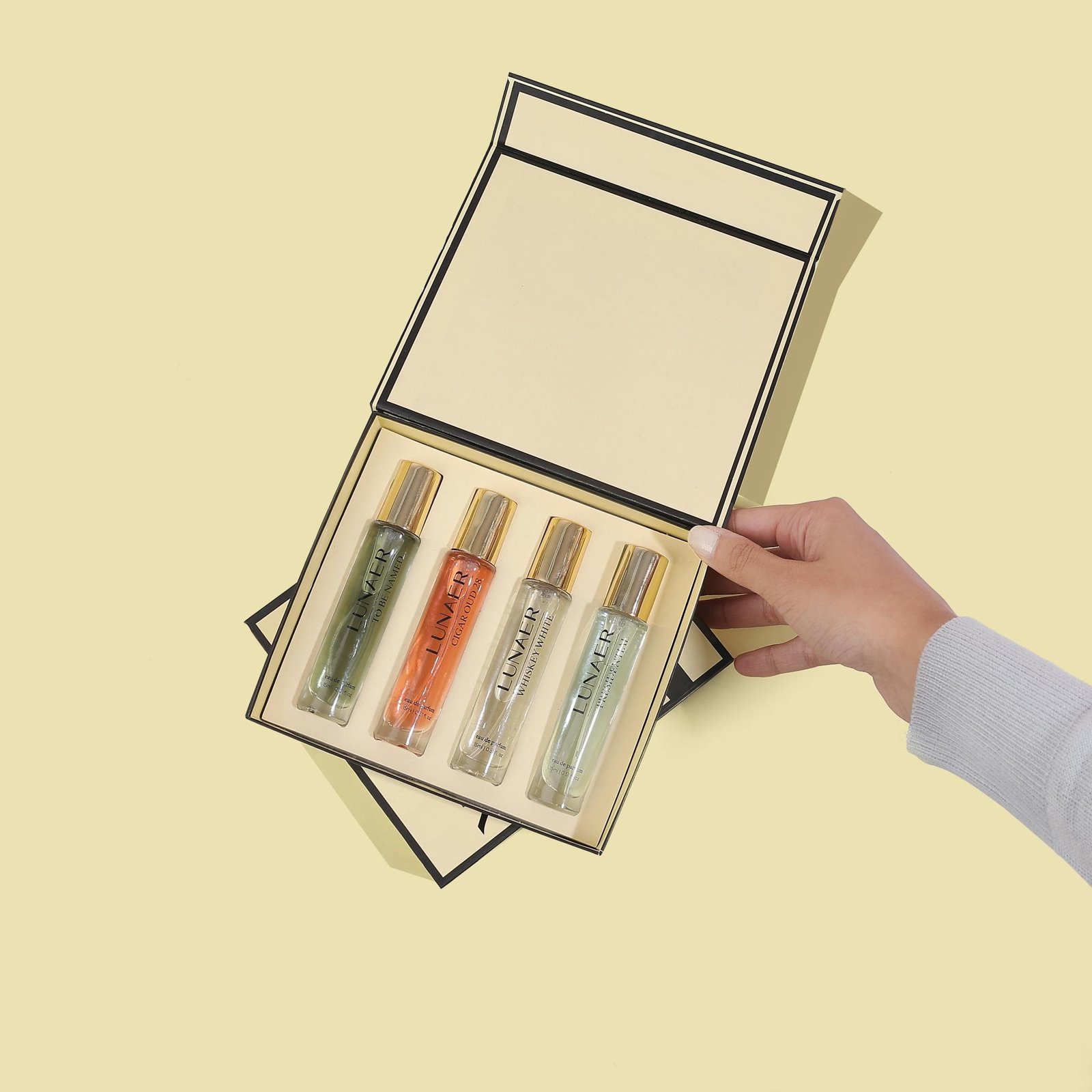 A stylish collection of four perfume vials in a chic gift box, ideal for a luxurious gift.